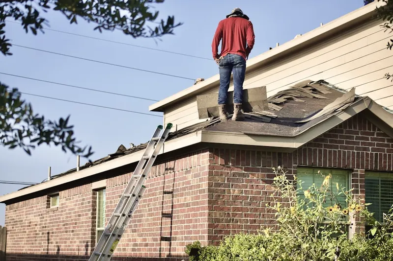 Professional roofer working on a residential roof in American Lake Garden Tract
